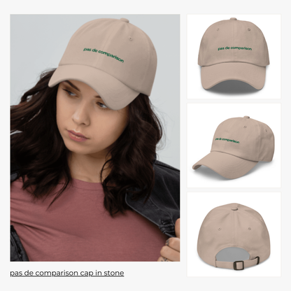 model wears 'pas de comparison' cap in stone