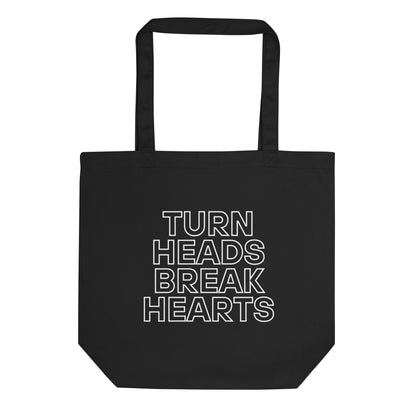 durable tote bag in black with printed ‘turn heads, break hearts’ slogan