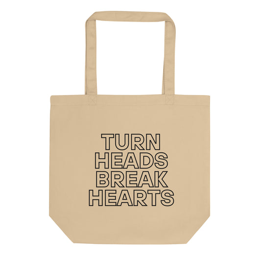 durable tote bag in stone with printed ‘turn heads, break hearts’ slogan